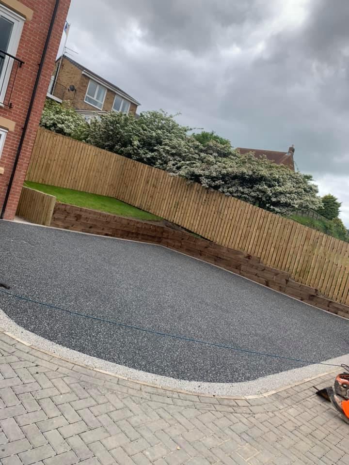Light grey driveway with curved block edging
