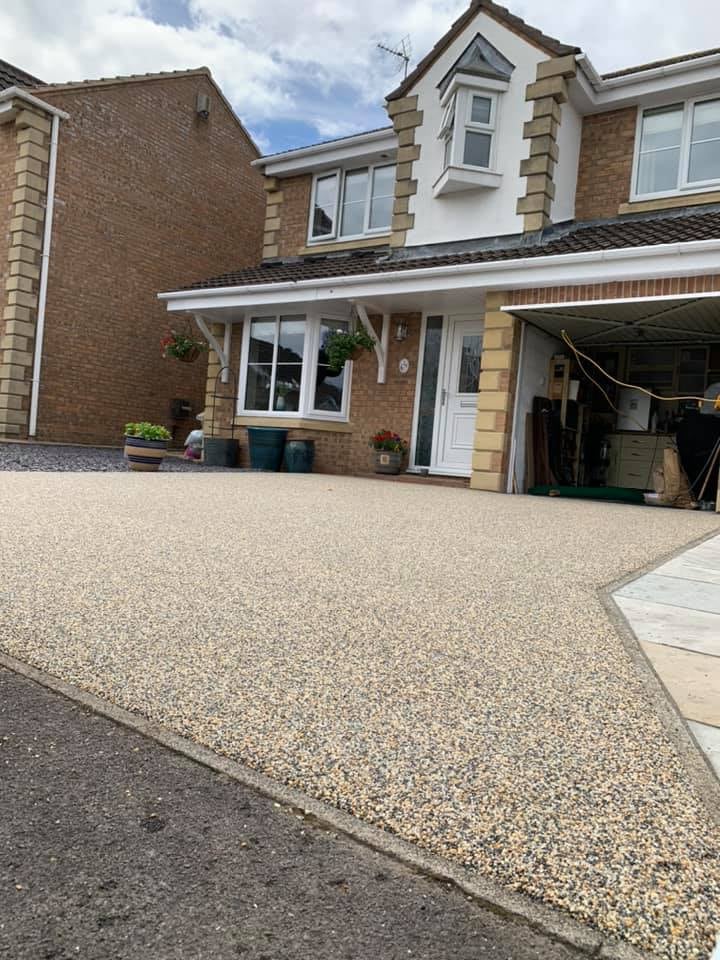 Large golden resin driveway outside a family home
