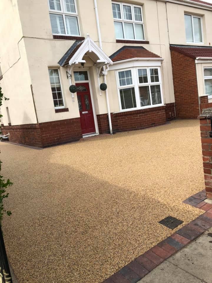 Golden resin courtyard outside a cream-fronted home