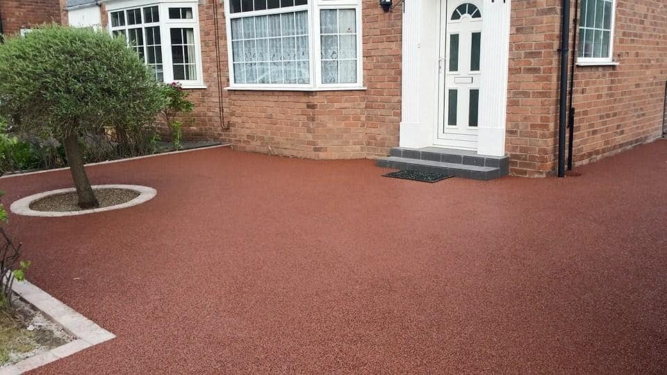Terracotta resin driveway with circular tree border